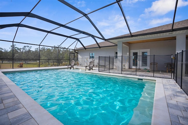 outdoor pool featuring french doors, a patio, and a lanai