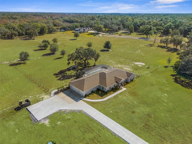 birds eye view of property featuring a forest view and a rural view