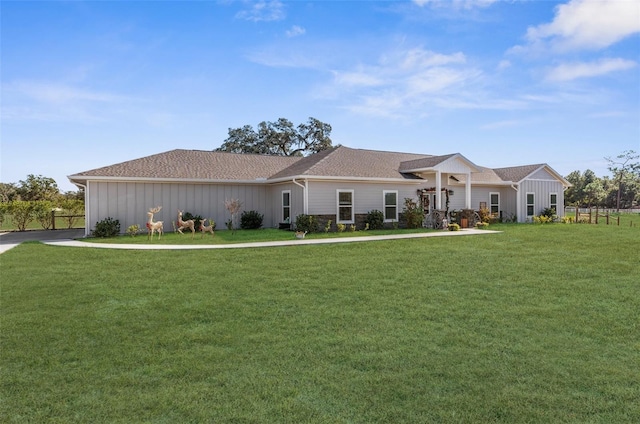 view of front of home with a front lawn and board and batten siding