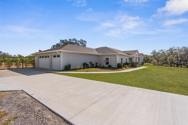 view of front of home with a garage, a front yard, concrete driveway, and fence