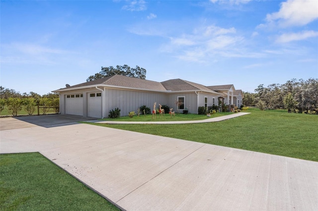 view of front of home featuring driveway, an attached garage, board and batten siding, and a front yard