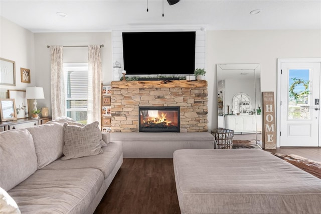 living room with a stone fireplace, wood finished floors, a ceiling fan, and recessed lighting