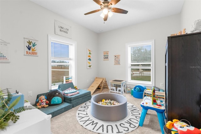 game room with carpet flooring and ceiling fan