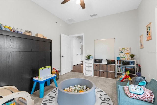 rec room with carpet floors, visible vents, and ceiling fan