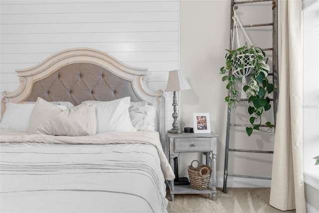 carpeted bedroom featuring baseboards