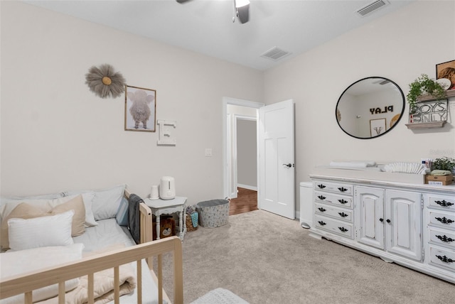 bedroom featuring light colored carpet, visible vents, and ceiling fan