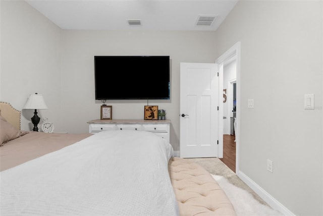 bedroom with visible vents and baseboards