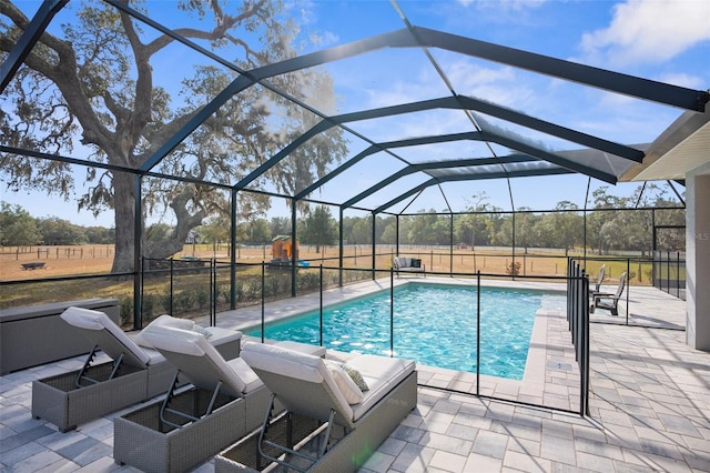 outdoor pool featuring a lanai and a patio