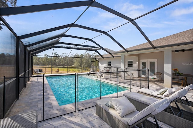 pool with a patio, french doors, and a lanai