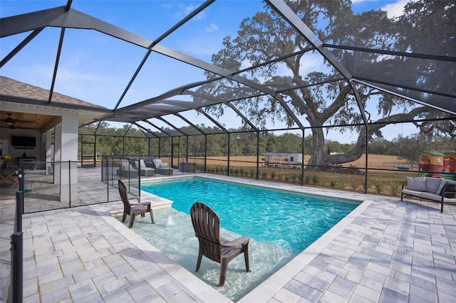 pool featuring a lanai, a patio area, and an outdoor hangout area