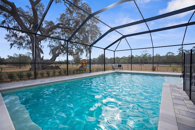 outdoor pool with glass enclosure and a patio