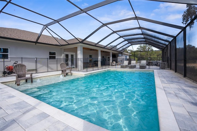 view of pool with a fenced in pool, french doors, a ceiling fan, a patio area, and a lanai