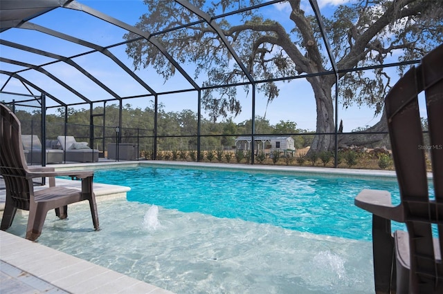 pool with a lanai and a patio area