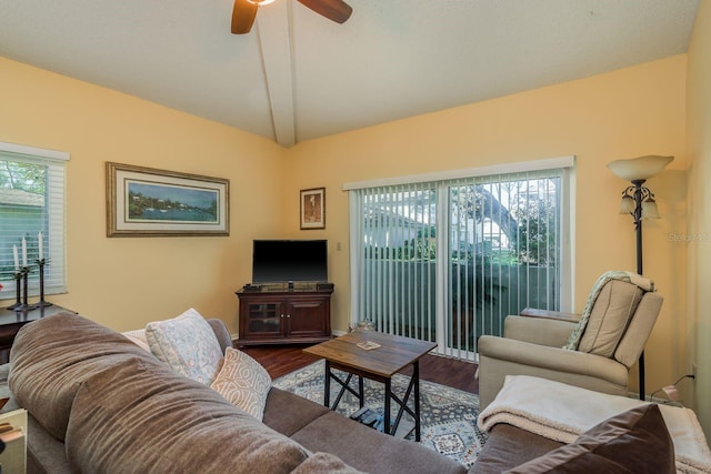 living room featuring ceiling fan, dark hardwood / wood-style flooring, and vaulted ceiling