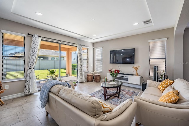 living room with light tile patterned floors and a healthy amount of sunlight