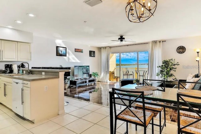 19811 Gulf Blvd Unit 102, Indian Shores, FL 33785 - kitchen with sink, white dishwasher, pendant lighting, light tile patterned floors, and ceiling fan with notable chandelier