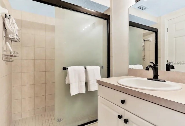 19811 Gulf Blvd Unit 102, Indian Shores, FL 33785 - bathroom featuring tile patterned floors, vanity, and a shower with shower door