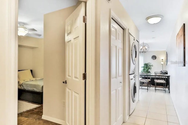 19811 Gulf Blvd Unit 102, Indian Shores, FL 33785 - hall featuring tile patterned floors and stacked washer and dryer
