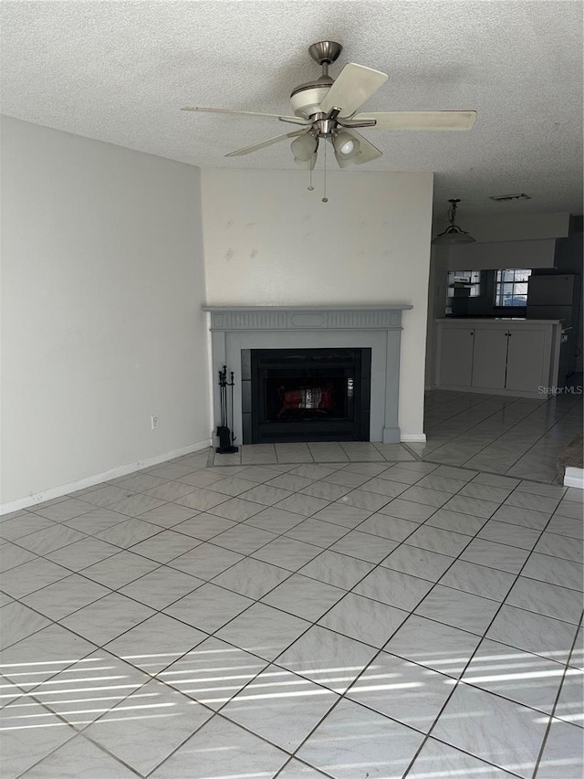 unfurnished living room with ceiling fan, a fireplace, and a textured ceiling