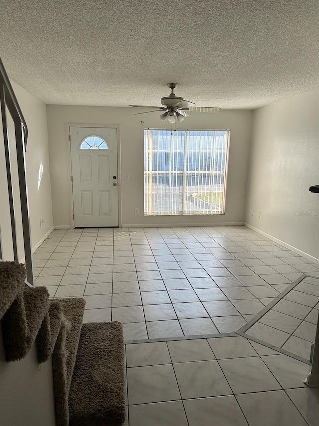 entryway with a textured ceiling and a healthy amount of sunlight