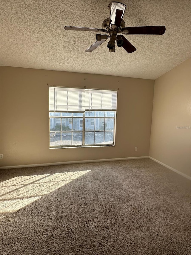 spare room with carpet flooring, ceiling fan, and a textured ceiling