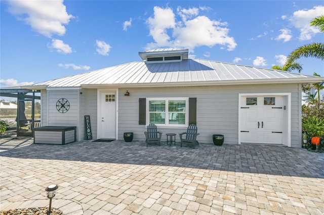 back of house featuring a garage