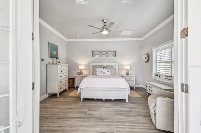 bedroom featuring light hardwood / wood-style flooring, ceiling fan, and ornamental molding