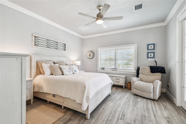 bedroom featuring light wood-type flooring, ceiling fan, and crown molding