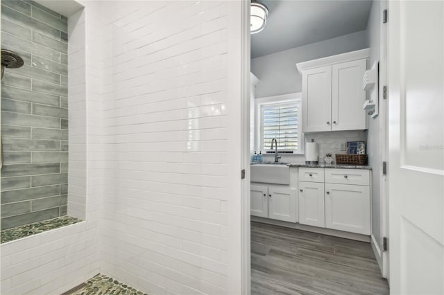 interior space featuring light stone countertops, light wood-type flooring, white cabinetry, and sink