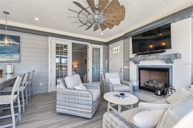 living room featuring wood-type flooring, wooden ceiling, and crown molding