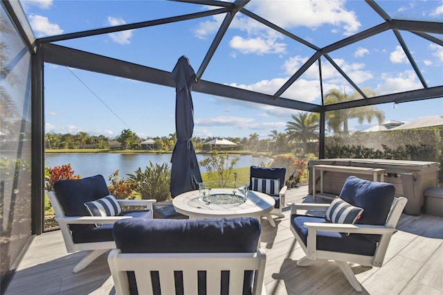 view of patio / terrace with glass enclosure and a water view