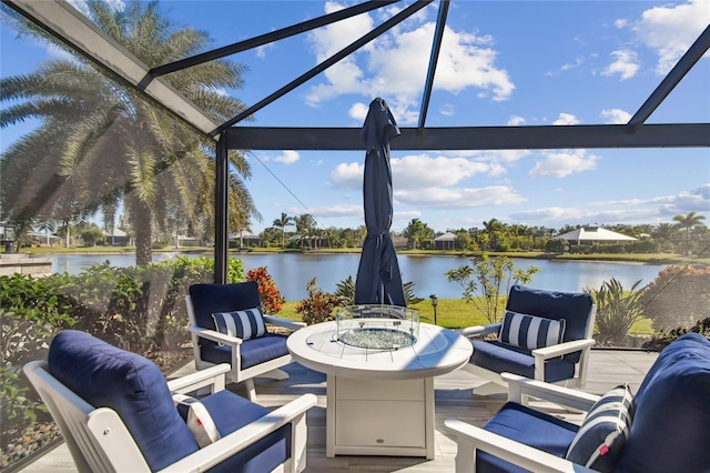 view of patio / terrace with glass enclosure, a water view, and an outdoor hangout area