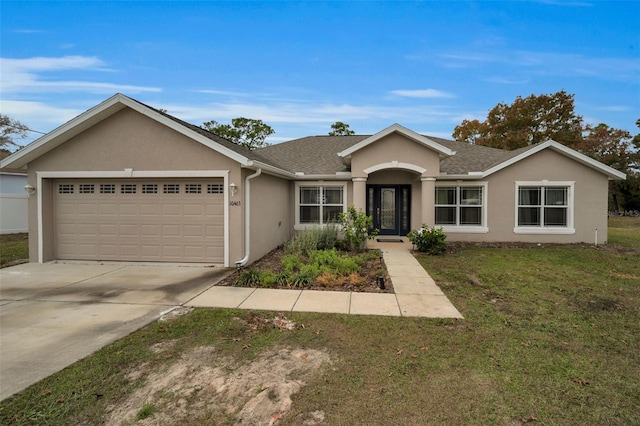 ranch-style home featuring a garage and a front lawn