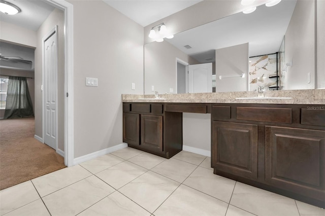 bathroom featuring tile patterned floors, vanity, and ceiling fan