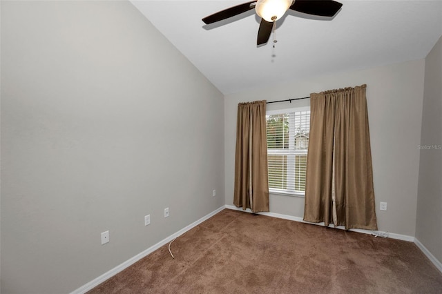 carpeted empty room featuring vaulted ceiling and ceiling fan