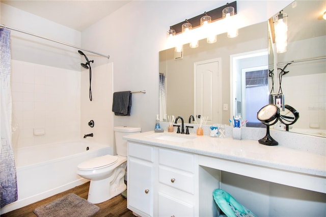 full bathroom featuring hardwood / wood-style floors, vanity, shower / tub combo, and toilet