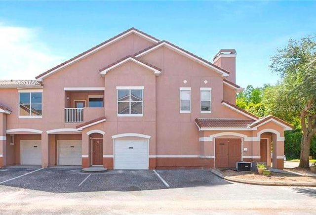 view of front of property featuring a balcony and a garage