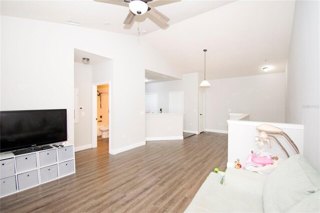 living room featuring ceiling fan, lofted ceiling, and hardwood / wood-style flooring