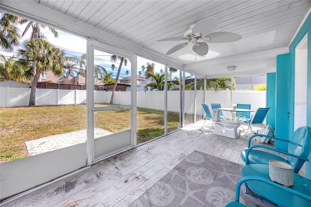 sunroom / solarium featuring ceiling fan