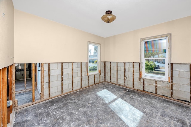 unfurnished room featuring tile walls