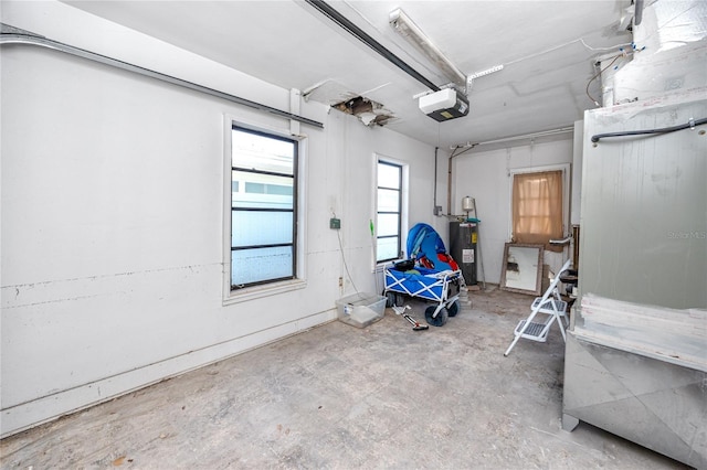 garage with electric water heater and a garage door opener