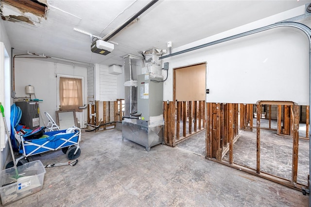 garage featuring electric water heater, wooden walls, and a garage door opener