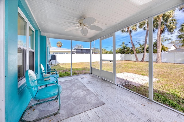 unfurnished sunroom featuring ceiling fan