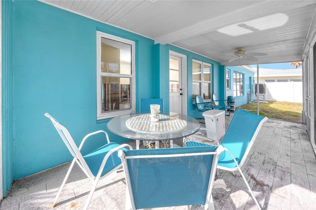 sunroom / solarium featuring ceiling fan