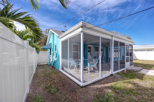 back of house with a patio area and a sunroom