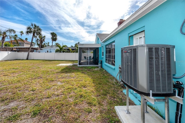 view of yard featuring a sunroom and cooling unit