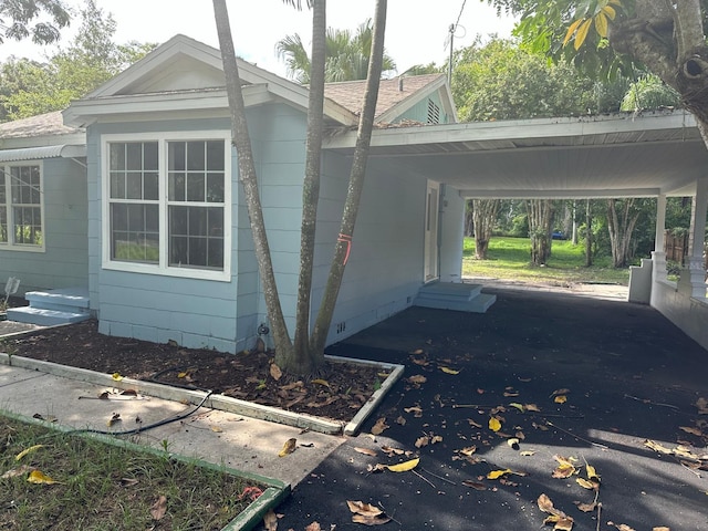 view of side of property featuring a carport