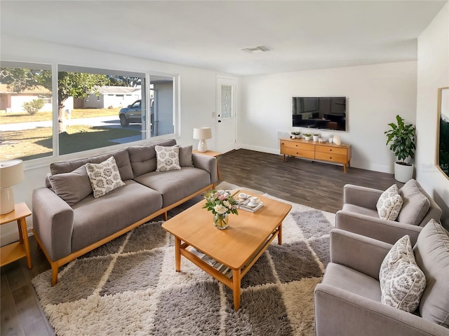 living room with dark hardwood / wood-style flooring