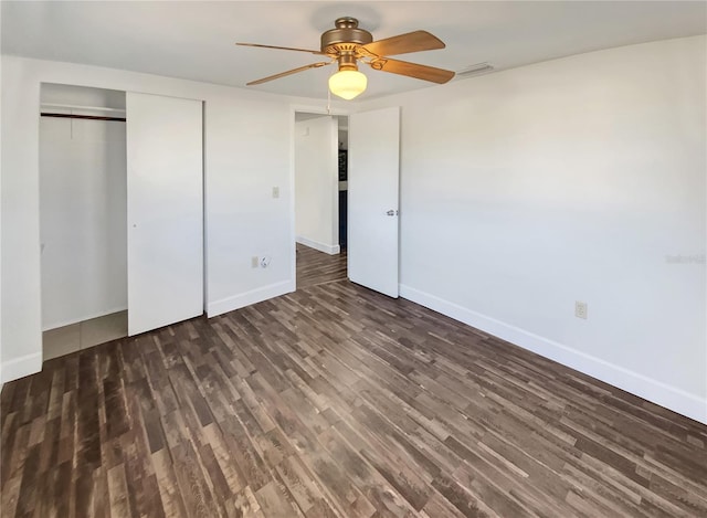 unfurnished bedroom with a closet, ceiling fan, and dark hardwood / wood-style flooring