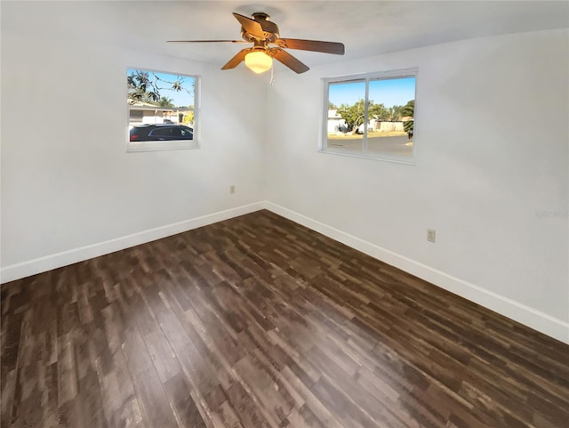 spare room with ceiling fan and dark hardwood / wood-style flooring